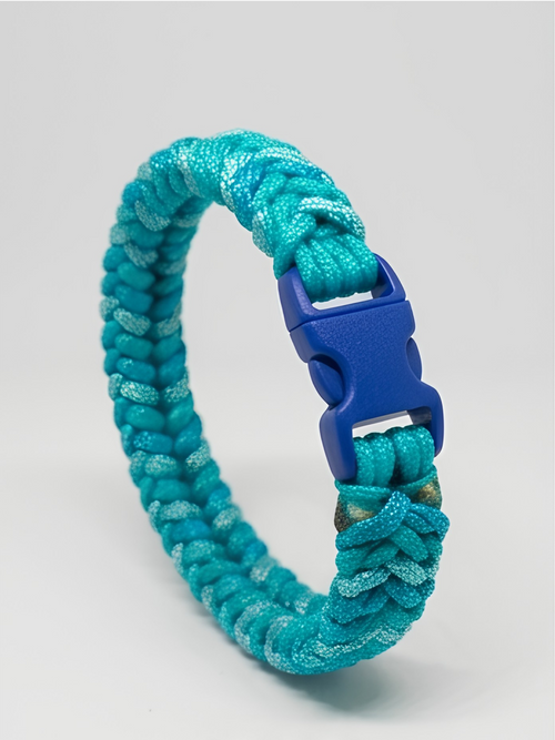 A turquoise paracord bracelet with a textured glitter finish and a blue plastic quick-release buckle, shown on a light gray background.